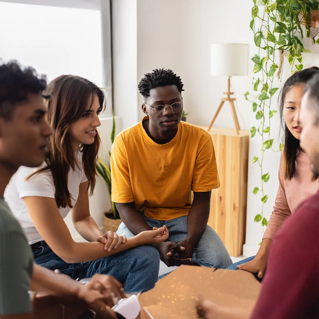 Diverse Group Sitting Together In Supportive Discussion