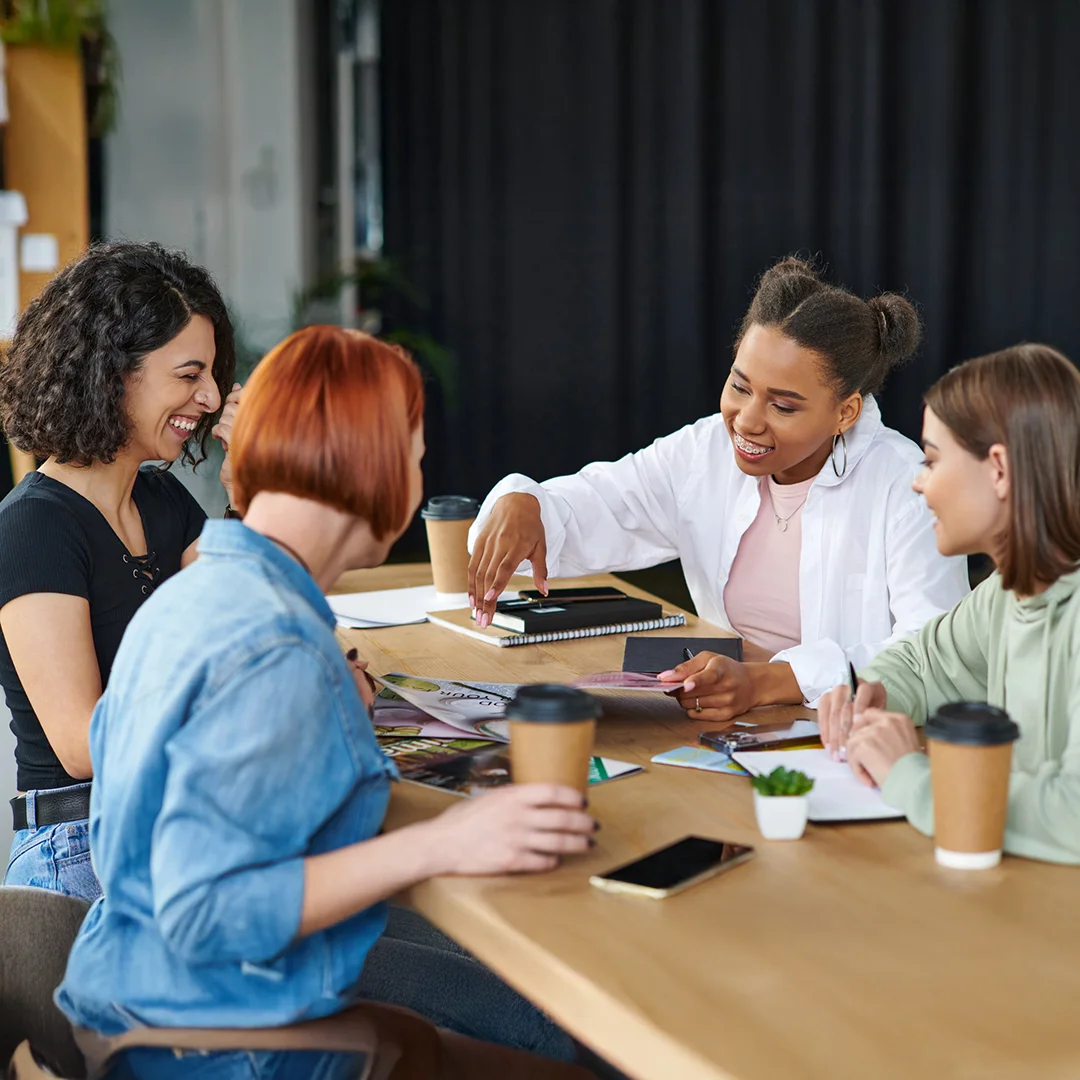 Team Collaborating Over Creative Materials In Office