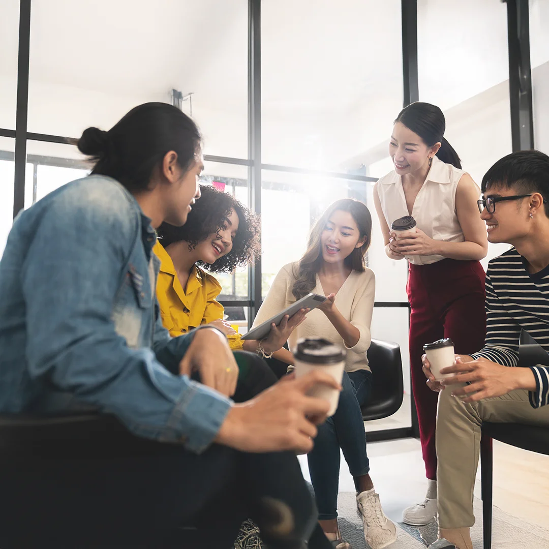 Team Reviewing Ideas Together In A Bright Office Lounge