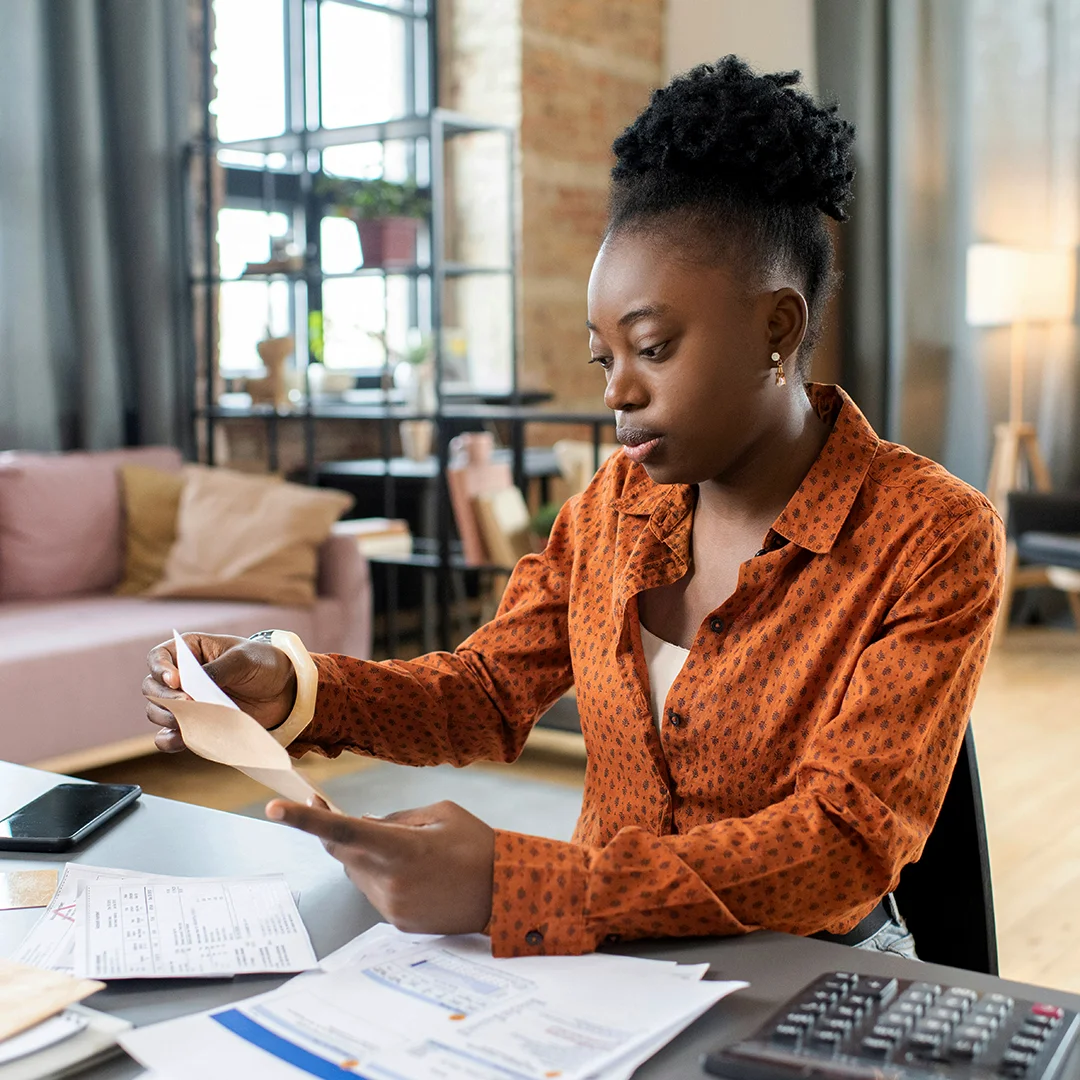 Woman Reviewing Bills And Paperwork At Home